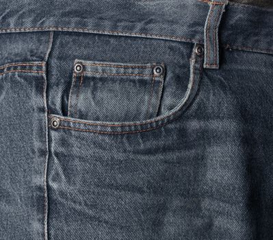 Worn dark washed denim jeans pocket detail textile background