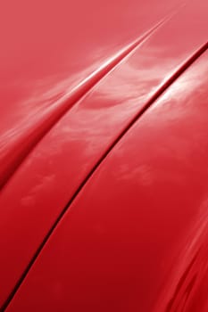 Red car shiny bonnet design curves detail background