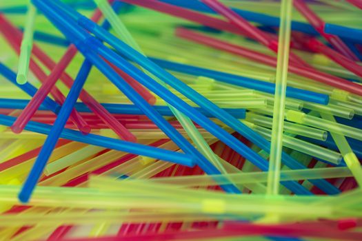 A pile of colourful childrens drinking straws