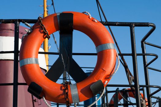 red life preserver on a ship board 