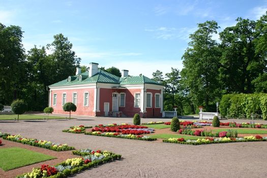 Small house with flower beds, the house and a garden