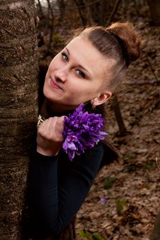 beautiful girl with snowdrops in a forest