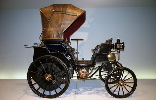 Old car with leather armchair and with big wheels