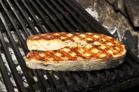 Salmon steak cooked on a grill in the restaurant