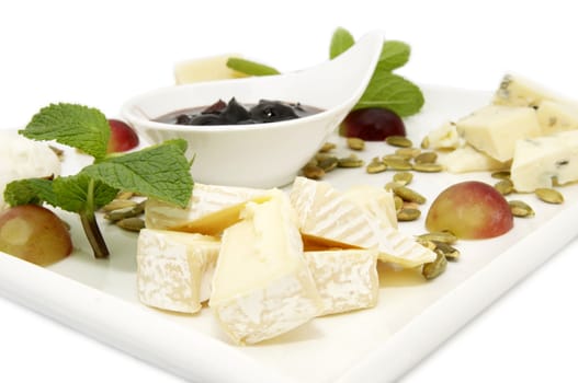 cheese plate with cheeses and sauce on a white background