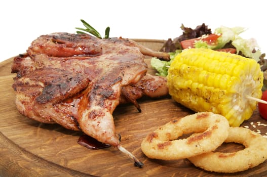 preparation of quail on the grill in the restaurant on a wooden plate