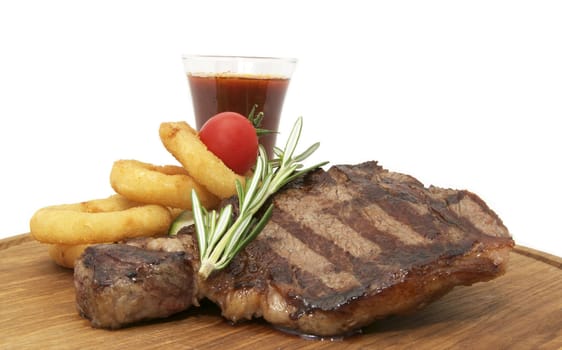 steak and sauce on a wooden plate over white background