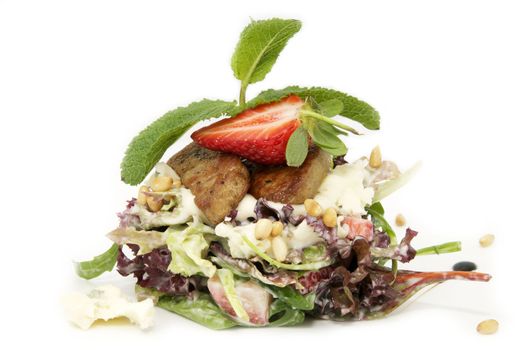 a salad of vegetables and meat on a white background