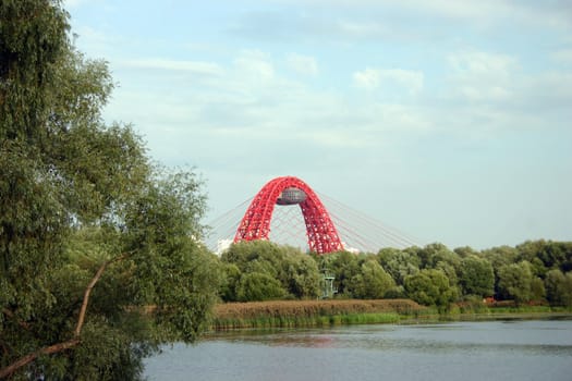 Red new bridge over the river in Moscow