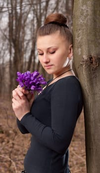 beautiful girl with snowdrops in a forest