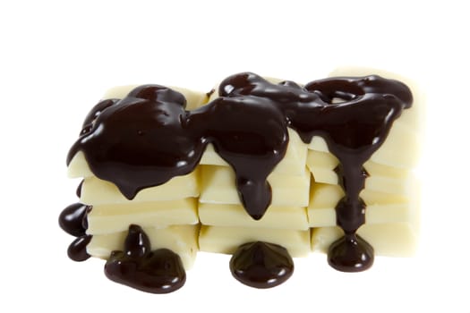 Picture of some pieces of white chocolate with brown chocolate poured over