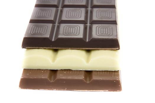Picture of one brown, one white, and one black chocolate