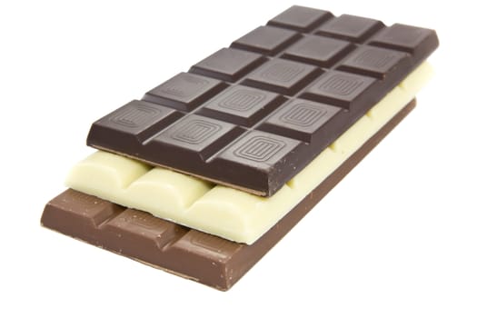 Picture of one brown, one white, and one black chocolate