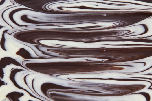 Picture of white and black chocolate mixed together forming a texture