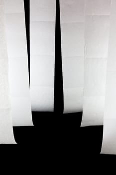 Picture of six hanging toilet papers on a black background