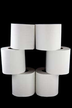 A picture of six toilet paper rolls stacked on top of eachother