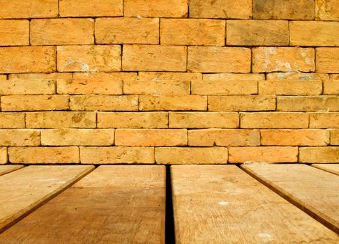 Orange brick wall and brown wood floor