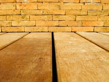 Orange brick wall and brown wood floor