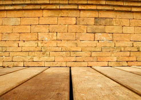 Orange brick wall and brown wood floor