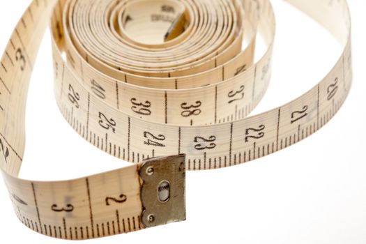 Measuring tape close up on a light background