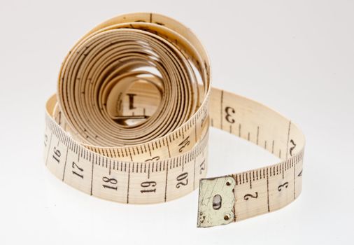 Measuring tape close up on a light background