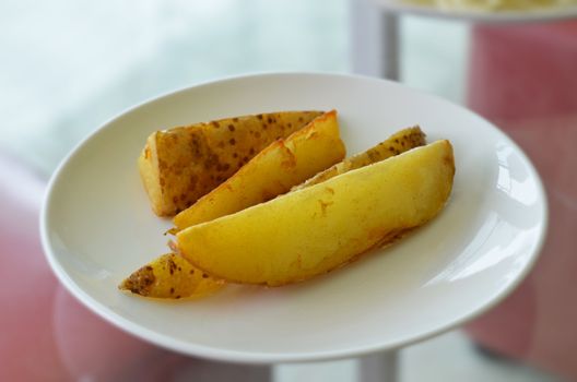 Grilled  potatoes on white dish