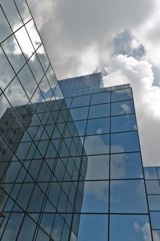 Clouds reflected in windows of modern office building