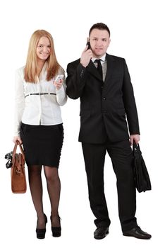 Studio shot of a young couple using mobile phones against a white background.