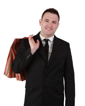 Image of a smiling young businessman with a shopping bag isolated against a white background.