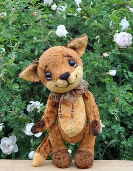 Ron fox cub on a board among flowers. Handmade, the sewed plush toy