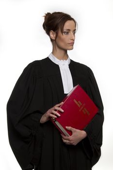 Women dress as a canadian attorney, holding a red book of criminal law with bilingual text on it