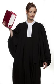 Women dress as a canadian attorney, holding a red book of law