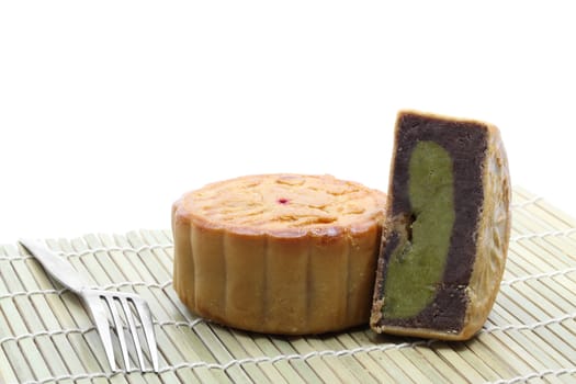 chinese moon cake with fork on bamboo dish