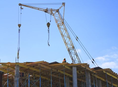 Crane working on the construction of the building and construction workers