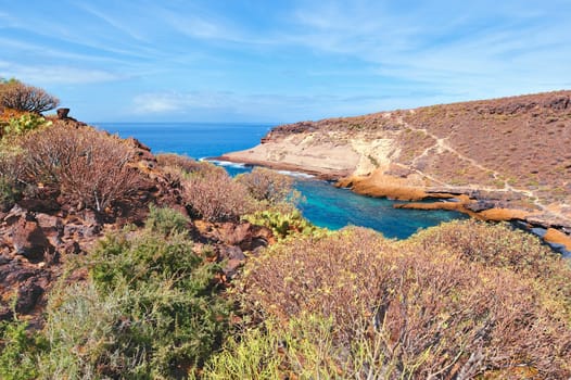 The coast of a rocky beach. Sunny day in Tenerife