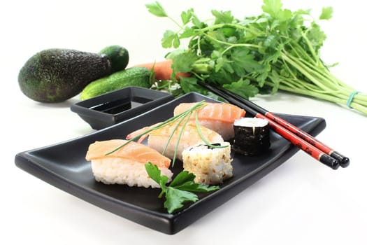 variety of sushi with parsley and chives