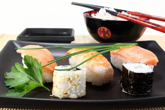 variety of sushi with parsley and chives