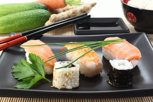 variety of sushi with parsley and chives