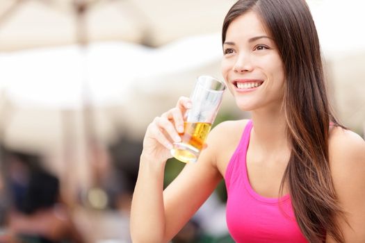 Woman on cafe drinking drink smiling happy looking at copy space. Asian young woman drinking alcohol, rum, in Havana, Cuba.
