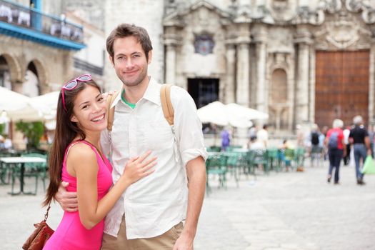 Cuba tourists in Havana. Happy couple portrait during travel in Havana, Cuba, Asian woman, Caucasian man smiling happy on Plaza de la Catedral, Old Havana.