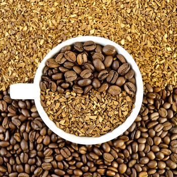 Coffee beans and grains in a white cup on the background of the grains and coffee granules