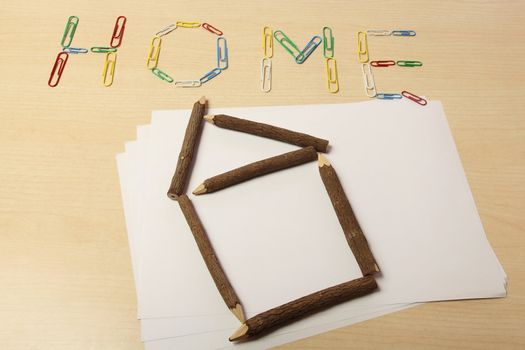 Home with paper clips and with wood pencil