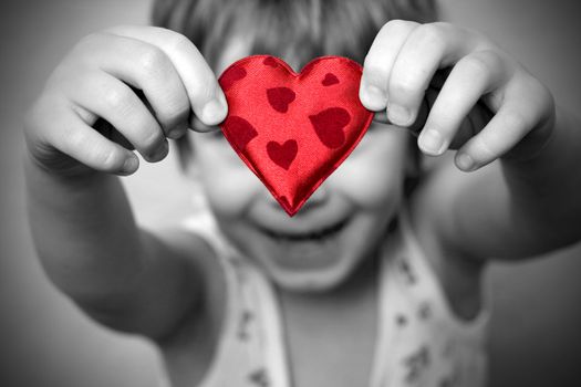 two hands holding a red heart