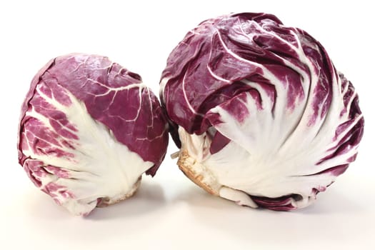 two heads of fresh radicchio on a light background