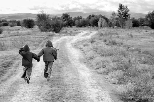 girl and boy standing or running on the road