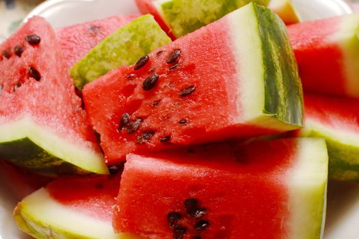 Juicy watermelon. Background of brightly lit watermelon slices.
