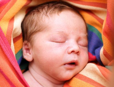 portrait of a close-up, infant lying on the bed