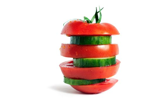 sliced ripe tomato and cucumber slices on a white background