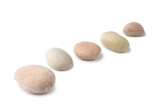Row of pebbles isolated on white background