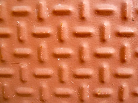closeup of a red dimpled metal surface